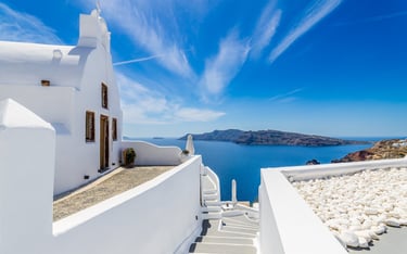 Santorin, Greece a white house with a view of the sea