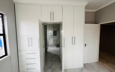 a white cupboards and cabinets in a room, House Construction Frans-del Investment CC Construction co
