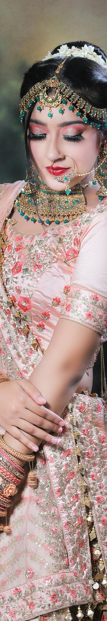 a woman in a pink dress and jewelry