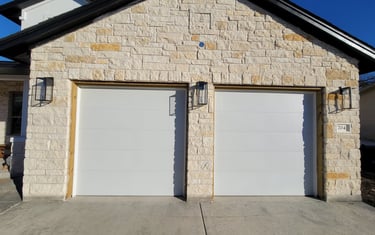 White Flush style garage doors installed by On Point Overhead Doors in Manor TX