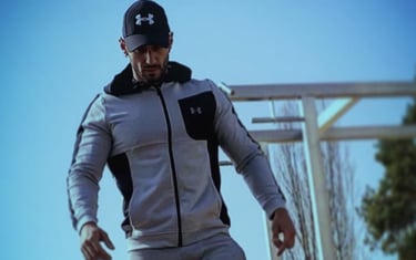 a man in a gray jacket and black pants