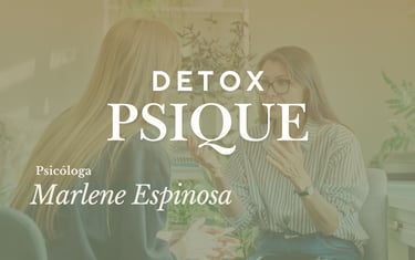 a woman in a striped shirt and glasses sitting at a desk