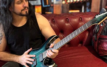 a man with long hair and a guitar