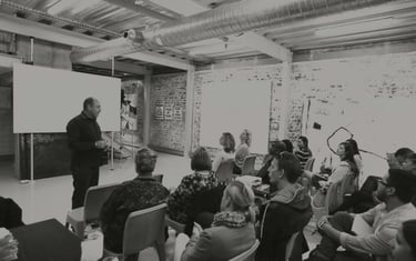 Martin Osner teaching a group of students in a workshop at the Photography School and Art Academy.