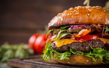 a hamburger with all of the trimmings