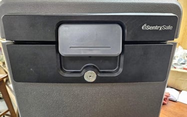 Professional locksmith servicing a SentrySafe fireproof home safe