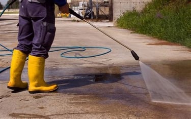 Pressure washing services worker pressure washing a dirty sidewalk