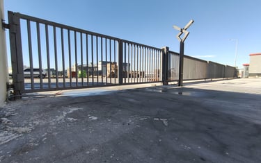 a gated fenced in area with a fenced in area with a fence