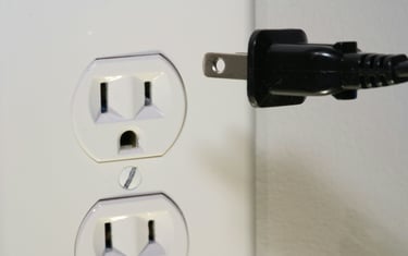 A device being unplugged from electric socket