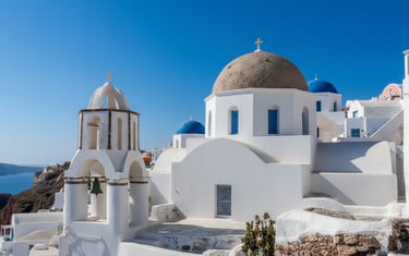 Iconic white buildings and blue domes of Santorini, Greece.