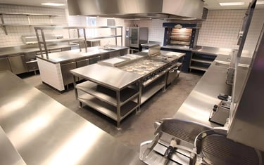 Professional kitchen featuring a custom stainless steel bench Brisbane.