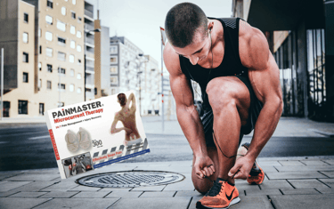 Young man runner doing his shoe laces with a painmaster box next to him.