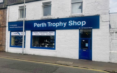 front of Perth trophy Shop with a blue sign