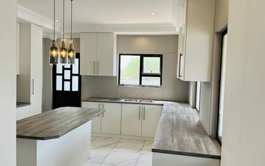 a kitchen with a marble counter top and a wooden counter top, House Construction Frans-del Investmen