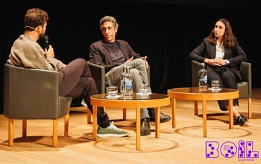a man and woman sitting in chairs in a room