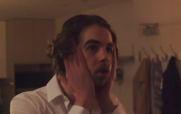 a man with a beard and a white shirt