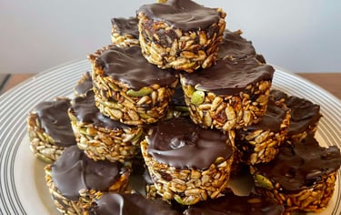 Crunchy seed bites topped with a smooth layer of Whittaker's 72% Dark Ghana Chocolate, offering a rich and indulgent treat