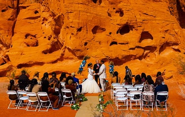 A desert wedding ceremony with a bride and groom at Valley of Fire State Park's red rock formations.