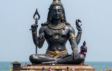 Giant black Lord Shiva statue at Azhimala Shiva Temple in Kerala, overlooking the Arabian Sea.