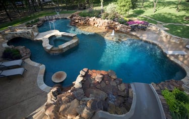 a pool with a waterfall and a jacuzzi