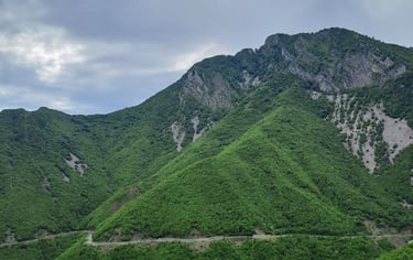 a mountain view of a winding road in the mountains