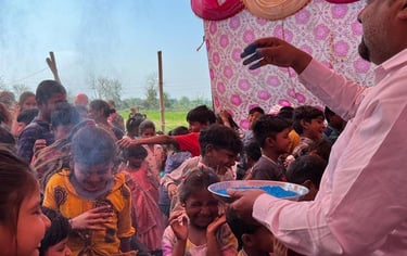 Teacher throwing blue powder over children who are having fun.