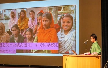 Kayoko giving a lecture on stage.