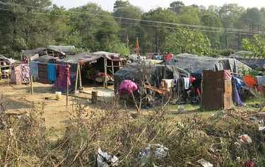 Small slum in Himachal Pradesh. Black tarpaulined dwellings.
