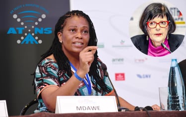 a woman in a colorful dress and glasses at a press conference