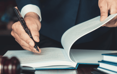 a judge's hand holding a gavel and a gavel
