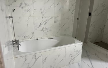 a bathtub with a marbled bathtub and a shower, House Construction Frans-del Investment CC Constructi