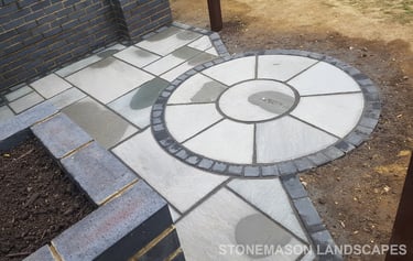 Grey sandstone circle paving slabs with charcoal edging