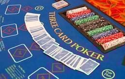 Three Card Poker table with blue felt