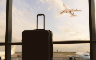 a suitcase and a suitcase in front of a window
