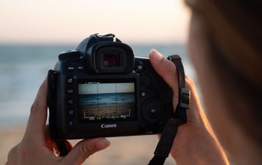 a person holding a camera and taking a picture of a camera