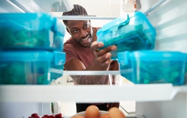 a man is smiling and holding a food container