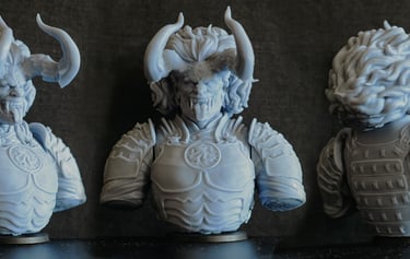 three different sized statues of a man with horns and horns