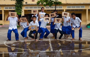 a group of children holding up signs in a school