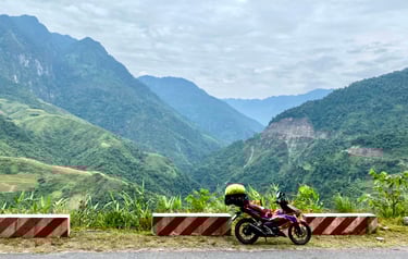 a motorcycle parked on a mountain side road