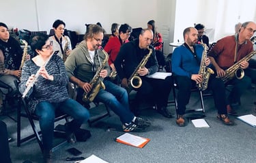 a group of people sitting in chairs playing instruments