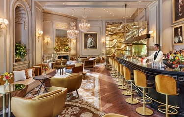 Pictura Bar – Luxurious cocktail bar with golden accents, plush seating, and classic artwork.