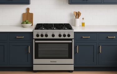 Blomberg gas range in a modern kitchen with navy cabinets and white tile backsplash.
