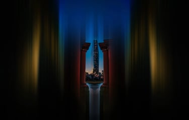 A long exposure shot of a modern skyscraper in London's skyline framed by artistic blurred architectural columns at night.