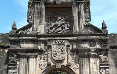 a large stone archway with a clock on it