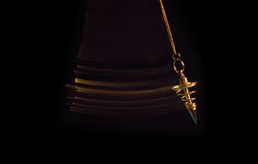 Gold pendulum used during a confidential paranormal assessment and spiritual consultation process