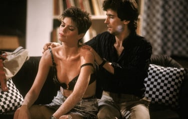 a man and woman sitting on a couch