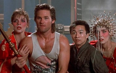 a group of people standing around a man in a red dress