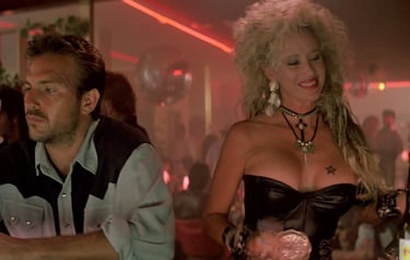 a man and woman in a bar with a drink