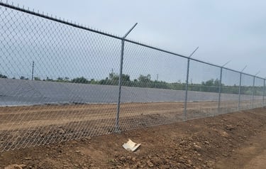 Chain link security fencing with barbed wire