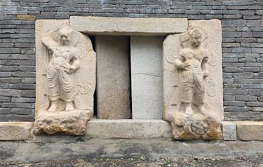 Sculpted guardian deities at a pagoda doorway